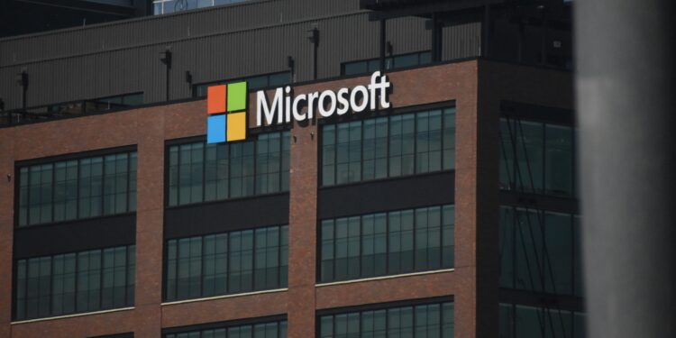 A tall building with a microsoft logo on top of it
