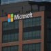 A tall building with a microsoft logo on top of it