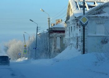Snow covered building against sky